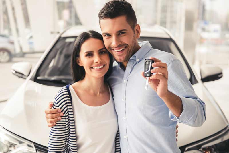 Happy woman financing her new car